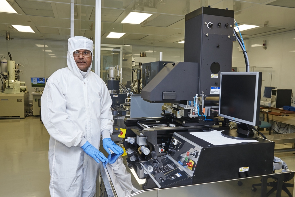 Photo: Professor Matiar Howlader standing with a Ultraviolet Nano-Imprint Lithography Tool capable of fabricating structures of tens of nano-millimeters in size over large areas for devices and components such as core elements of sensors and the critical elements of sample pre-processing modules